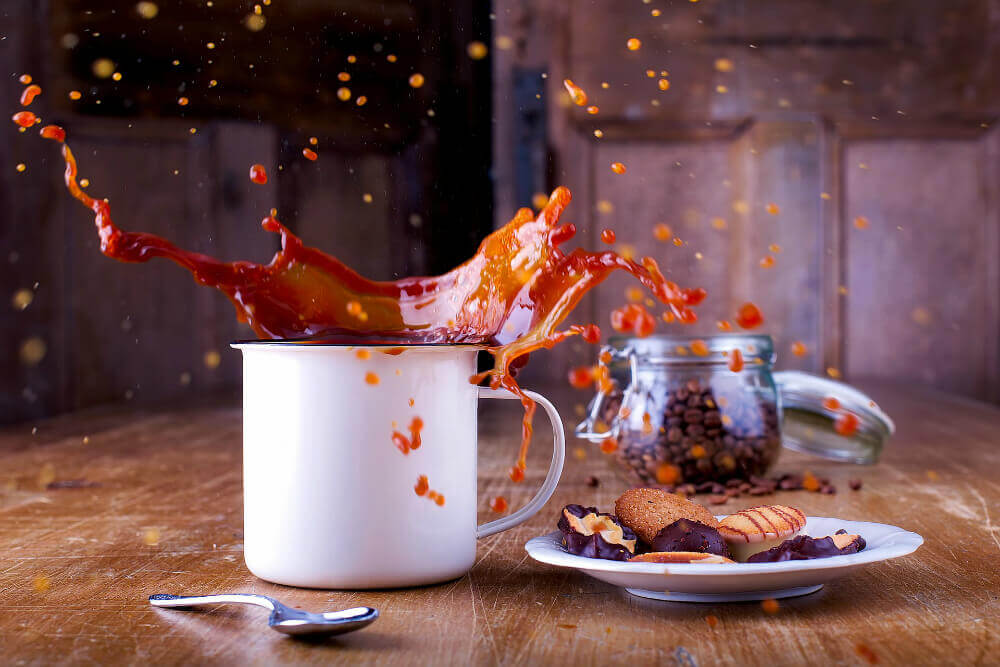 Coffee cup with coffee splashing out of it